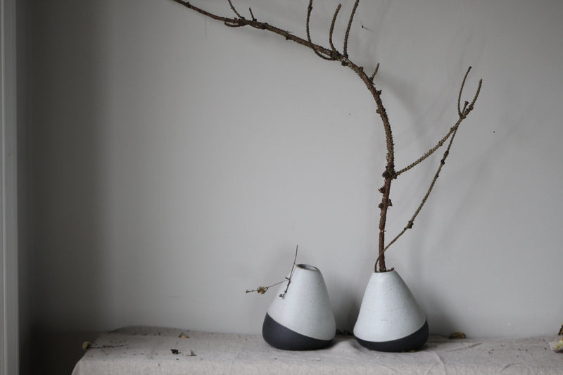 Tilted vase  set from black clay, waxy white glaze by GOLEM